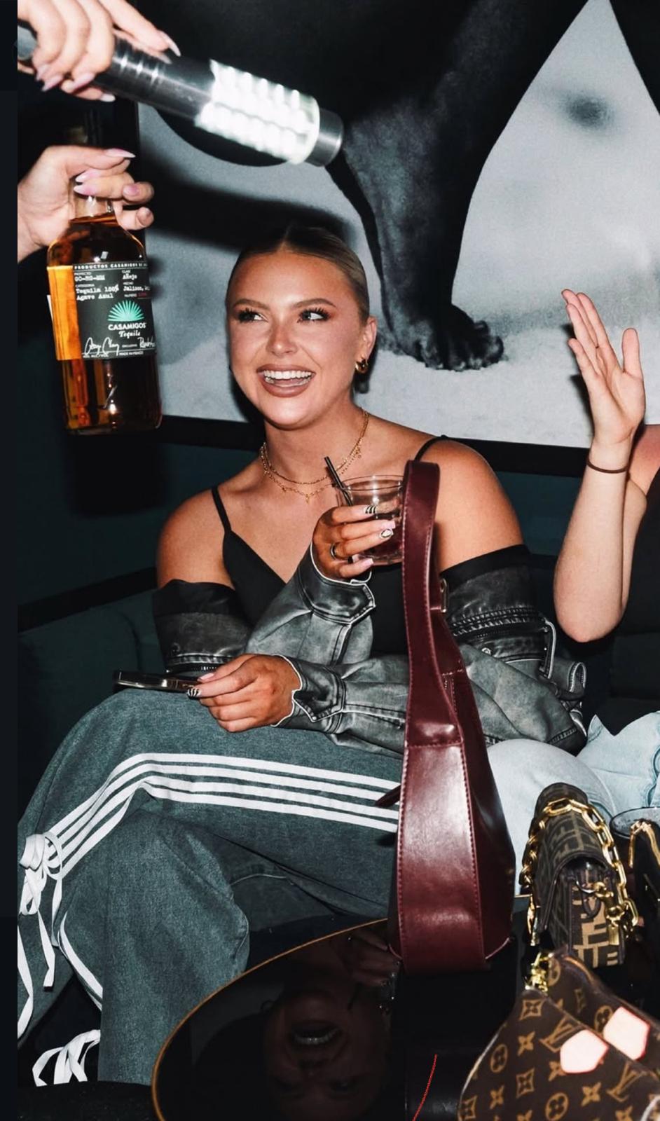 LED bottle service light baton illuminating a Casamigos tequila bottle in a VIP lounge setting