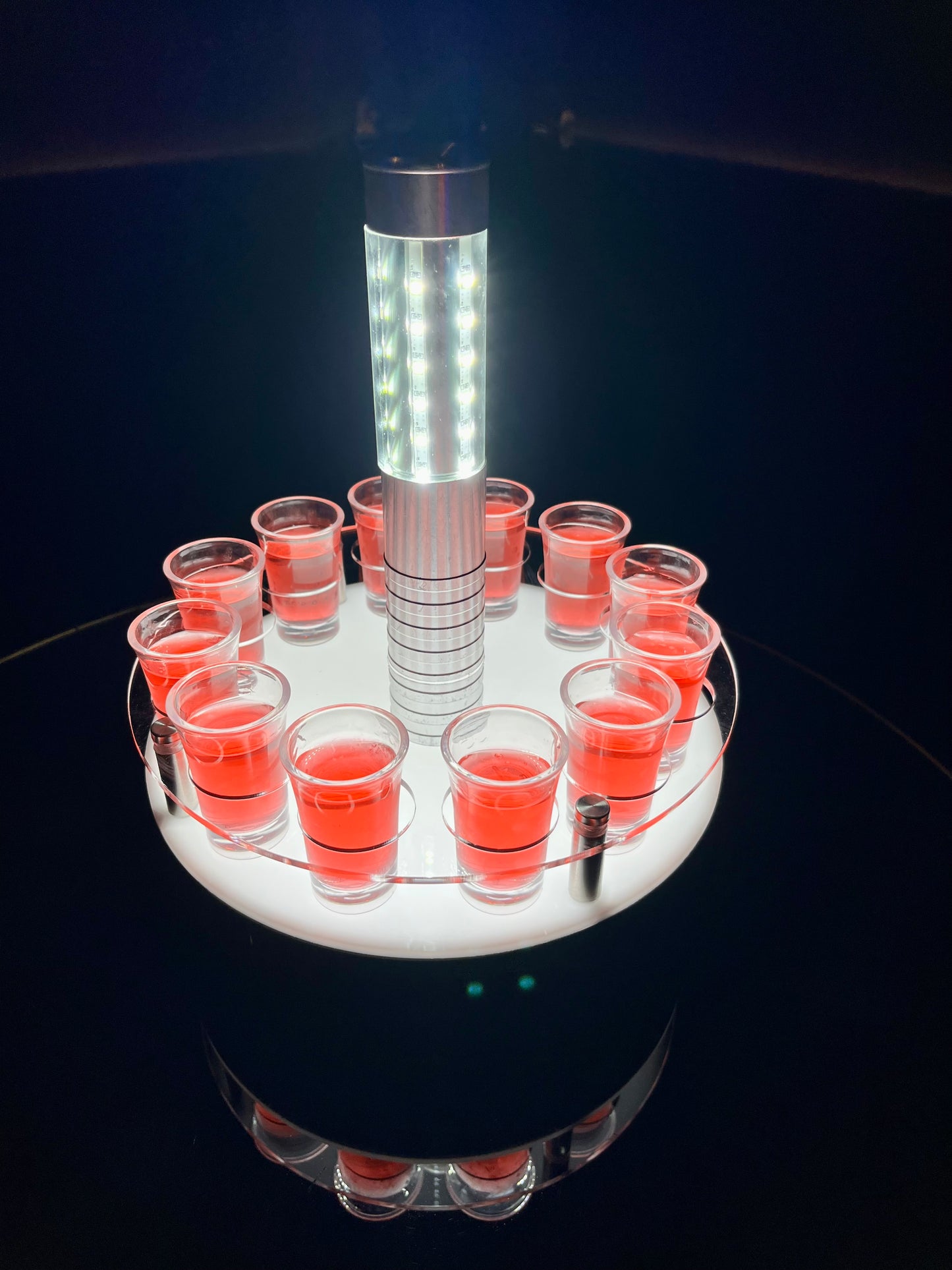 LED shot tray setup with red shooters and a bottle service light in the center