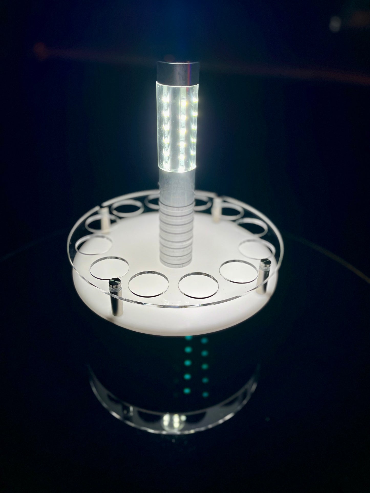 LED shot tray setup with a bottle service light in the center, displayed on a dark reflective surface